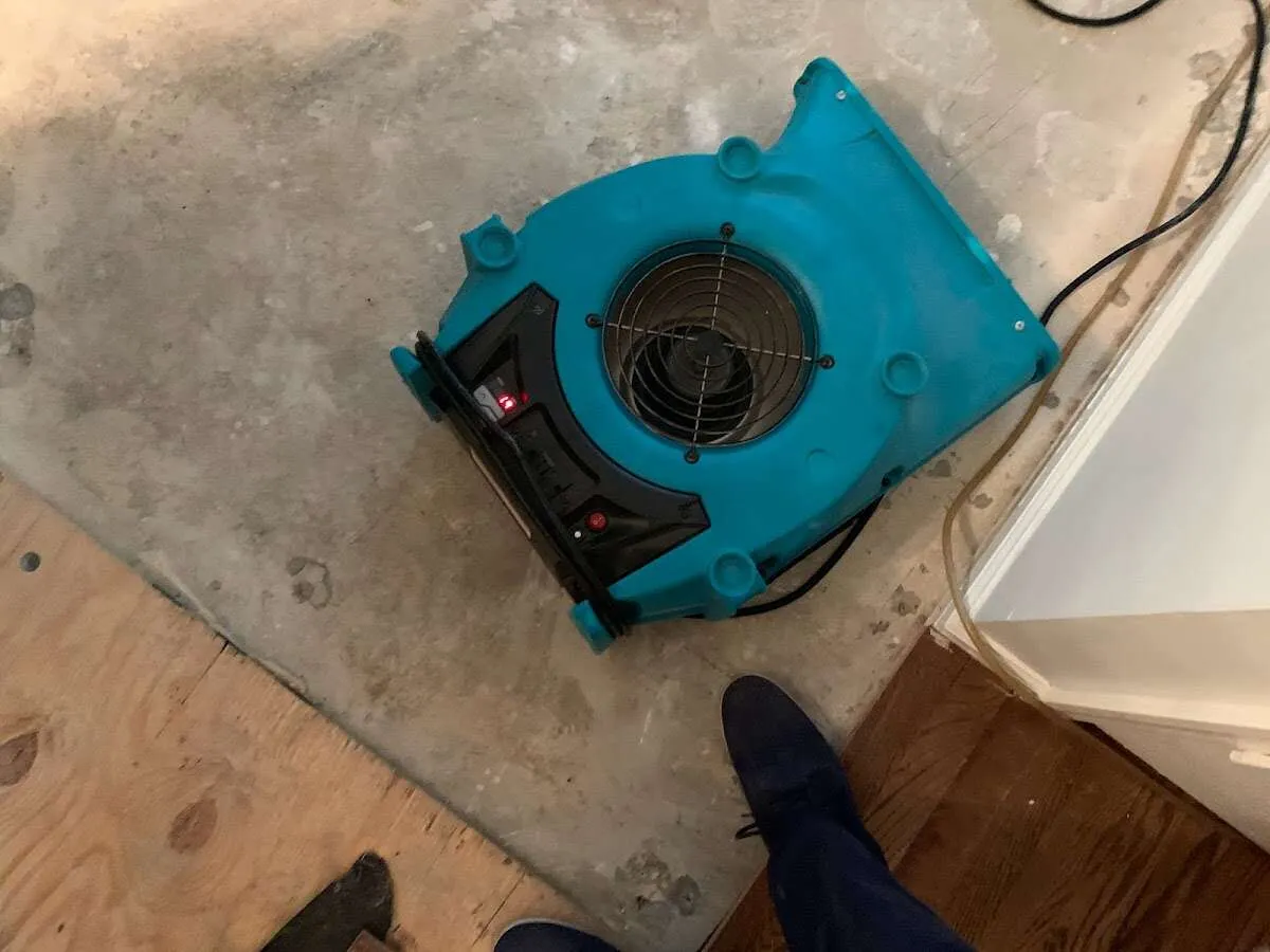 Air mover drying subfloor during Leak Detection & Repair in Elkhart